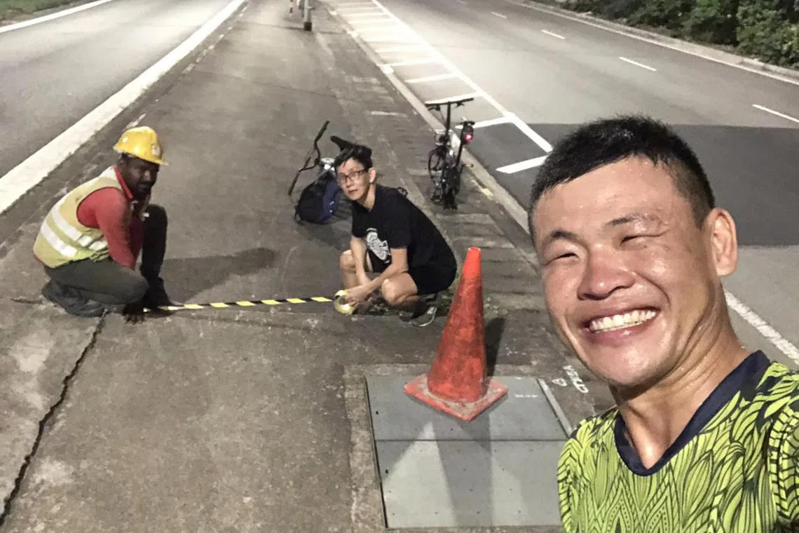 sabike28 - Mr Patrick Lee (in black shirt) and a worker pasting safety hazard tape at the crash site, while Mr Terence Lee (foreground, yellow shirt) takes a photo. 

pix credits: Terence Lee