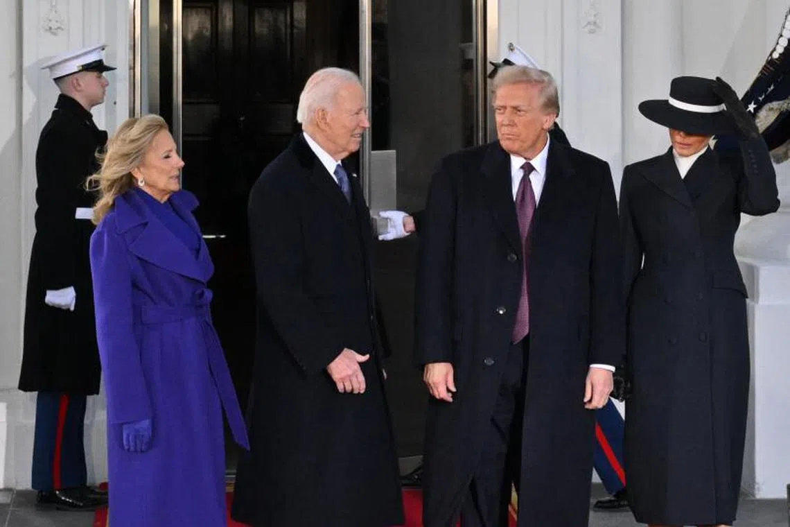 US President Joe Biden, First Lady Jill Biden (L) poses with President-elect Donald Trump (2nd R) and wife Melania Trump (R) as they arrive at the White House in Washington, DC, on January 20, 2025, before departing for the US Capitol where Trump will be sworn in as the 47th US President. (Photo by ROBERTO SCHMIDT / AFP)