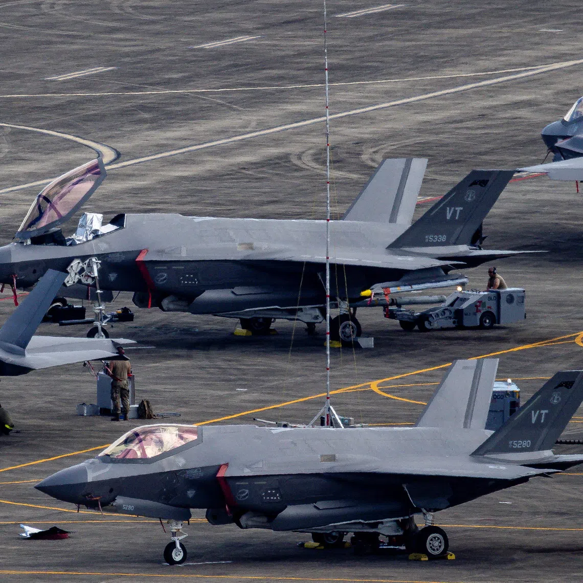 Personnel work on US Air Force F-35 Lightning II fighter jets parked on the tarmac at the former Roosevelt Roads naval base in Ceiba, Puerto Rico.