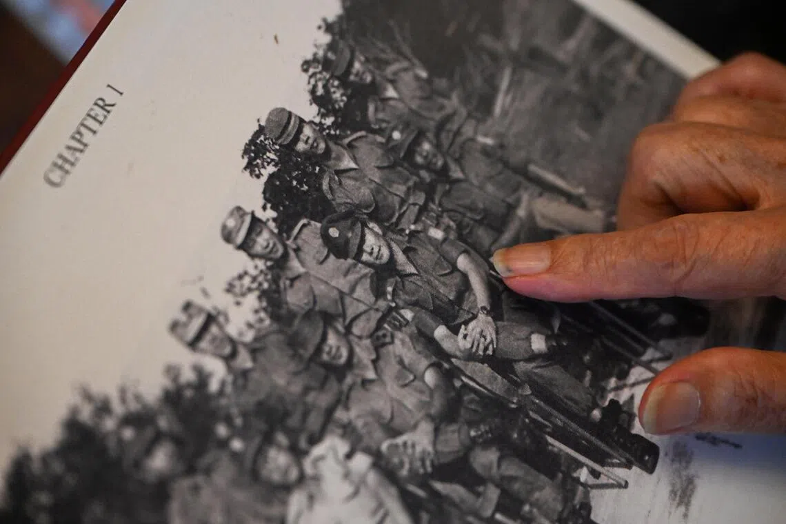Wong pointing to a younger picture of himself.