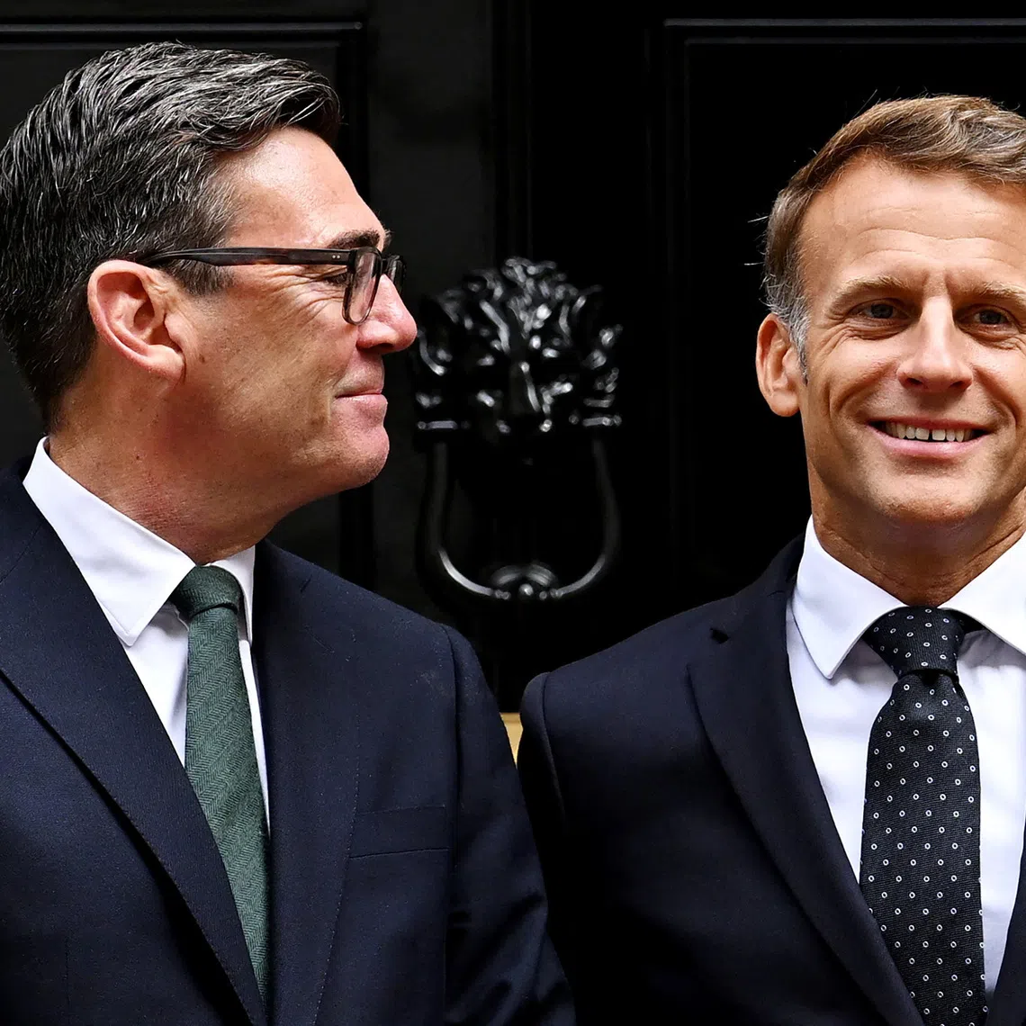 British Prime Minister Andy Burnham looks at French President Emmanuel Macron as they pose for photos ahead of a bilateral meeting at 10 Downing Street on September 03, 2026 in London, Britain. Leon Neal/Pool via REUTERS