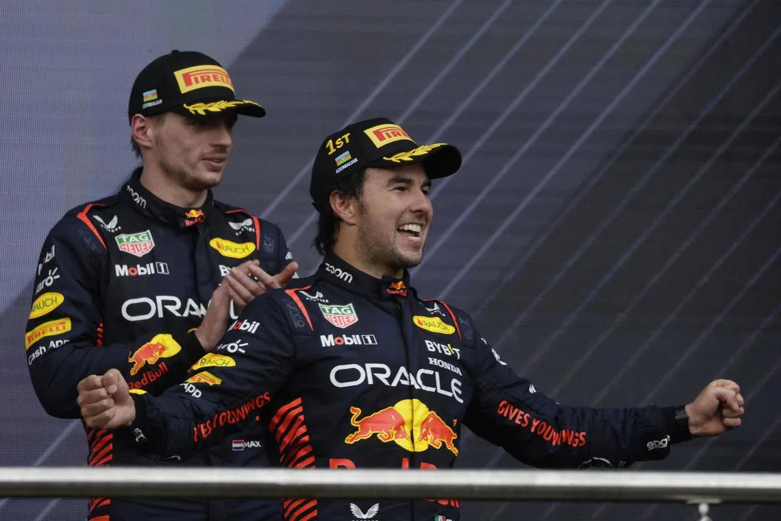 Red Bull's Sergio Perez celebrates on the podium after winning the race along with second-placed teammate Max Verstappen.