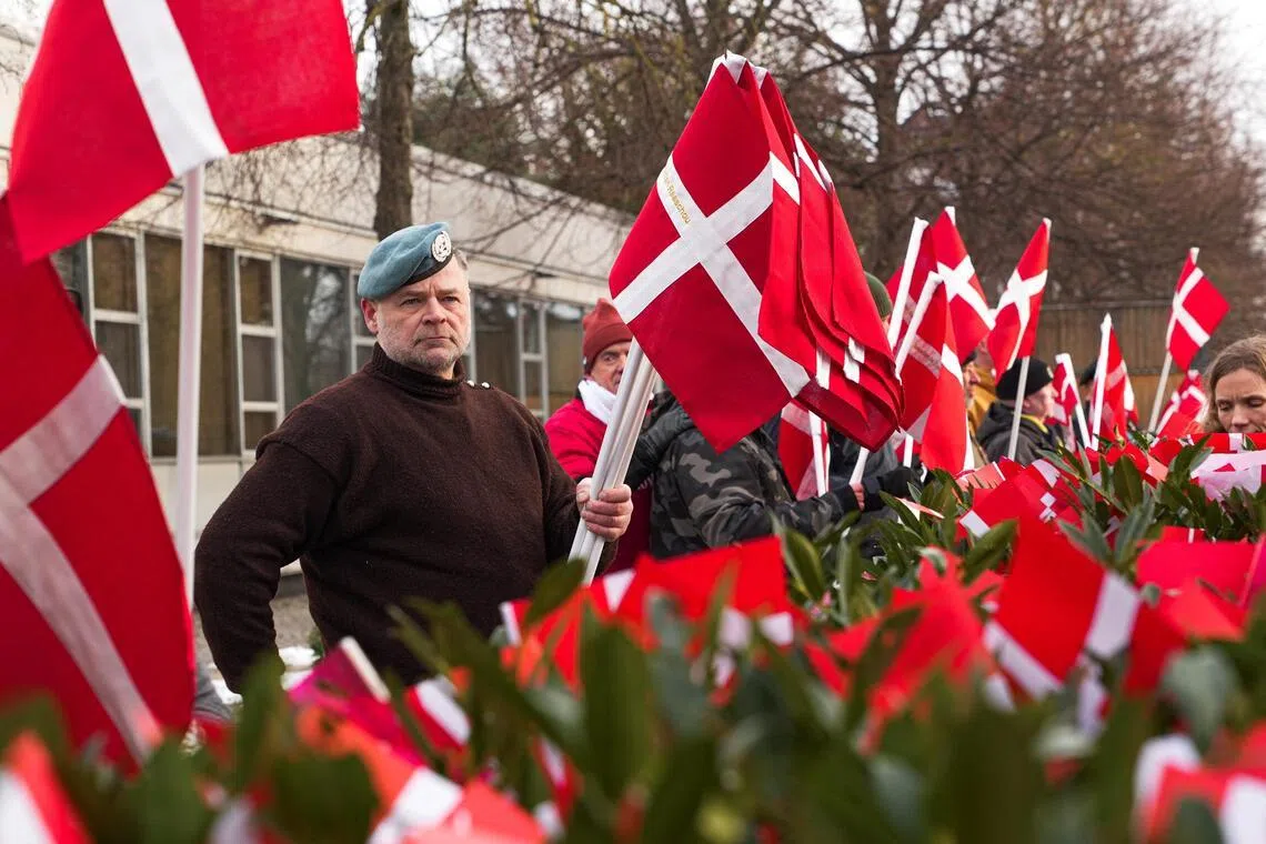 Protesters and veterans on Jan 31 planted Danish flags embroidered with the names of soldiers who died in Afghanistan and Iraq outside the US embassy in Copenhagen.