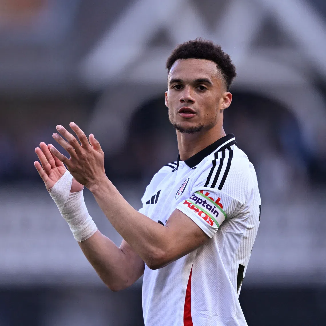 Soccer Football - Premier League - Fulham v Liverpool - Craven Cottage, London, Britain - April 6, 2025 Fulham's Antonee Robinson celebrates after the match REUTERS/Tony O Brien