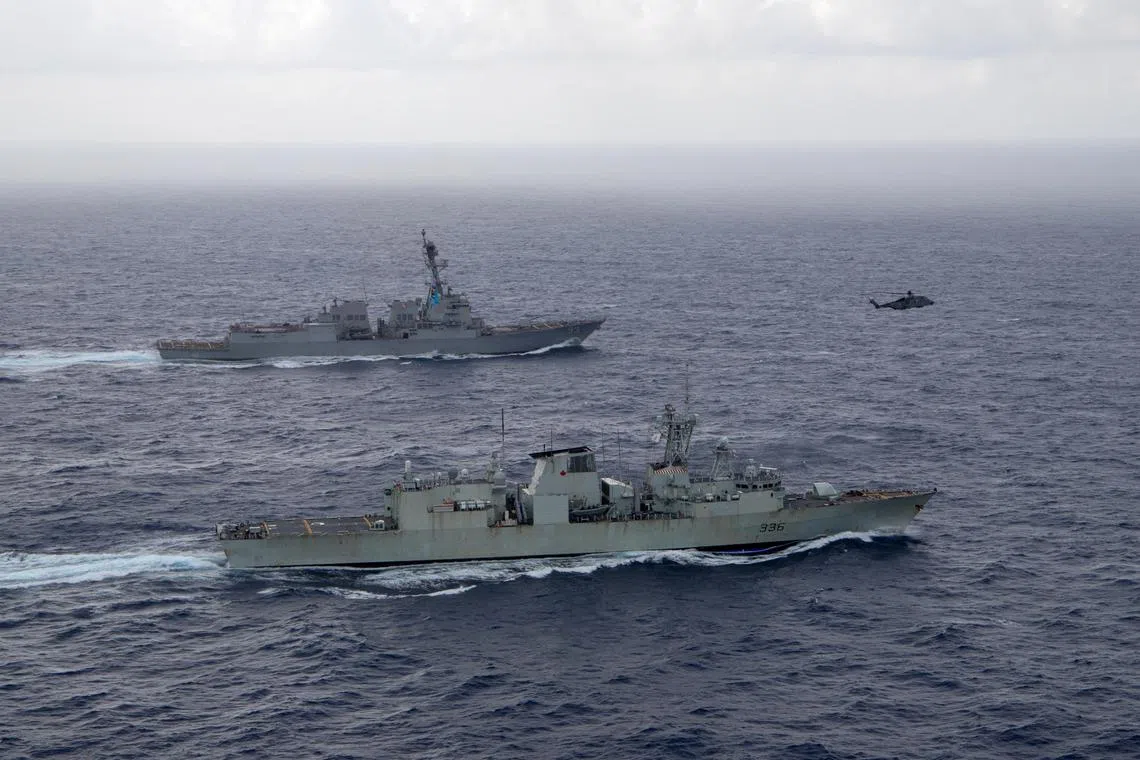 FILE PHOTO: U.S. Navy guided-missile destroyer USS Chung-Hoon sails alongside the Royal Canadian Navy frigate HMCS Montreal during Surface Action Group operations as a part of exercise “Noble Wolverine\" in the South China Sea May 30, 2023.  U.S. Navy/Naval Air Crewman (Helicopter) 1st Class Dalton Cooper/Handout via REUTERS/File Photo