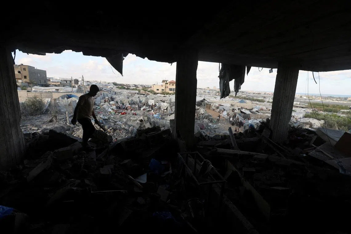 A Palestinian man inspecting the site of an Israeli strike on a house, near a tent camp sheltering displaced people that was damaged in the strike, in Khan Younis in the southern Gaza Strip June 7, 2026.