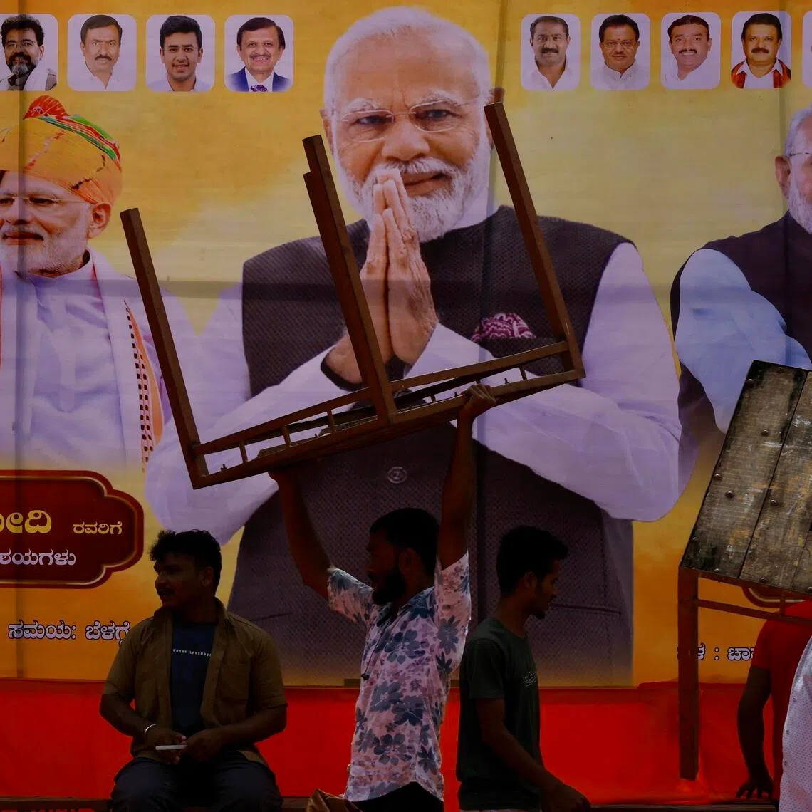 epa12384666 People in front of the billboard during Indian Prime Minister Narendra Modi's birthday celebrations in Bangalore, India, 17 September 2025. Bharatiya Janata Party (BJP)-led Indian Prime Minister Narendra Modi is celebrating his 75th birthday; he was born on 17 September 1950 in Vadnagar, Mehsana district, a small town in North Gujarat.  EPA/JAGADEESH NV