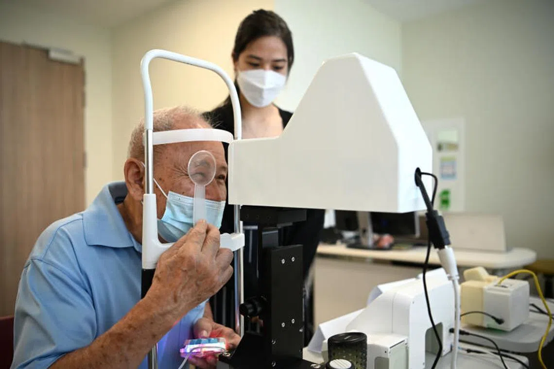 Mr Foong Yee Kong, 76, who has cataract, using the AVAT machine.