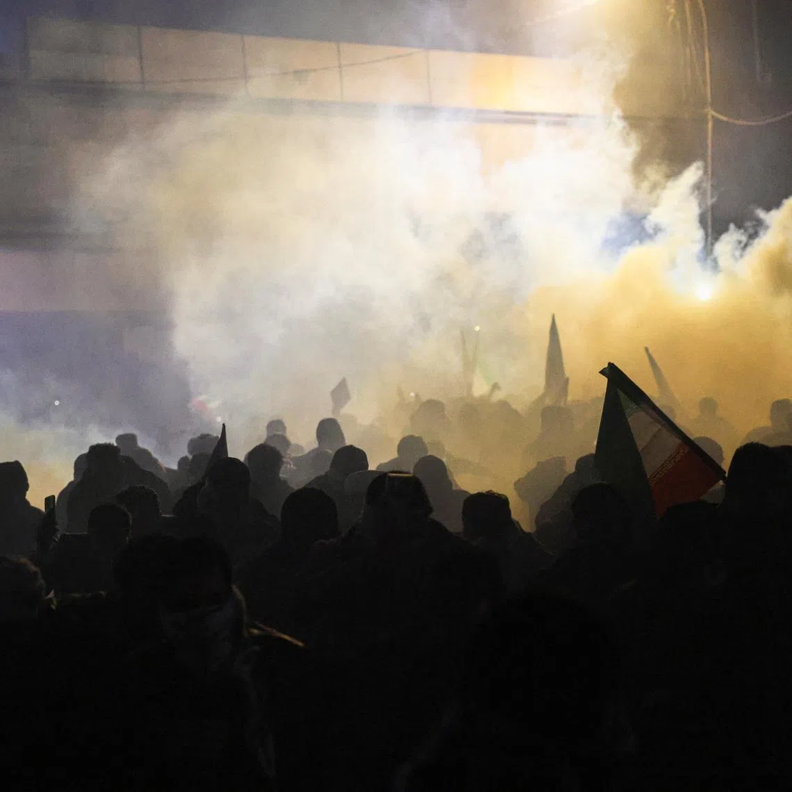 Protesters supporting Iraqi Shi'ite armed groups react to tear gas as they attempt to move toward the U.S. embassy located in Baghdad's Green Zone, as riot police deploy to block their advance, following the Israel and U.S. strikes on Iran and the killing of Iran's Supreme Leader Ayatollah Ali Khamenei, in Baghdad, Iraq, March 1, 2026. REUTERS/Ahmed Saad