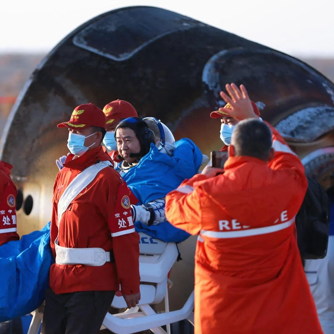 Shenzhou-20 commander Chen Dong (centre) back on Earth on Nov 14, after the  spacecraft was hit by suspected space debris, forcing a delayed return. 