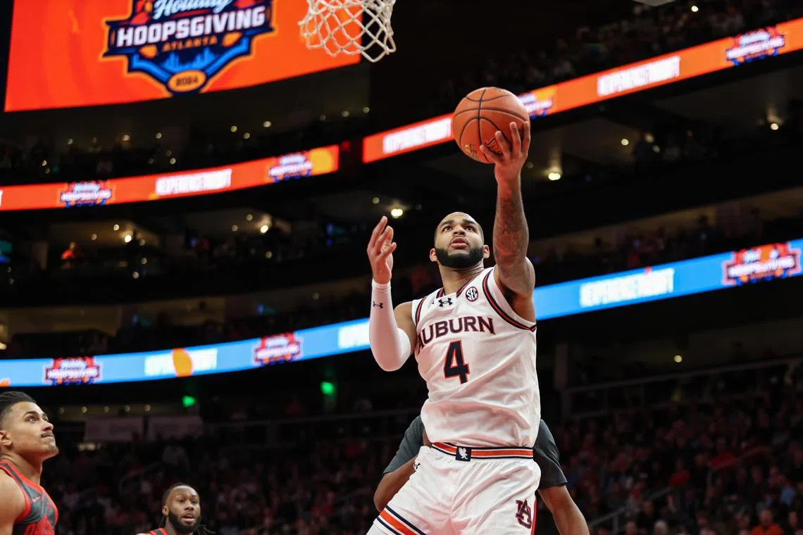 FILE PHOTO: Dec 14, 2024; Atlanta, Georgia, USA; Auburn Tigers forward Johni Broome (4) shoots the ball against the Ohio State Buckeyes during the first half at State Farm Arena. Mandatory Credit: Jordan Godfree-Imagn Images/File Photo