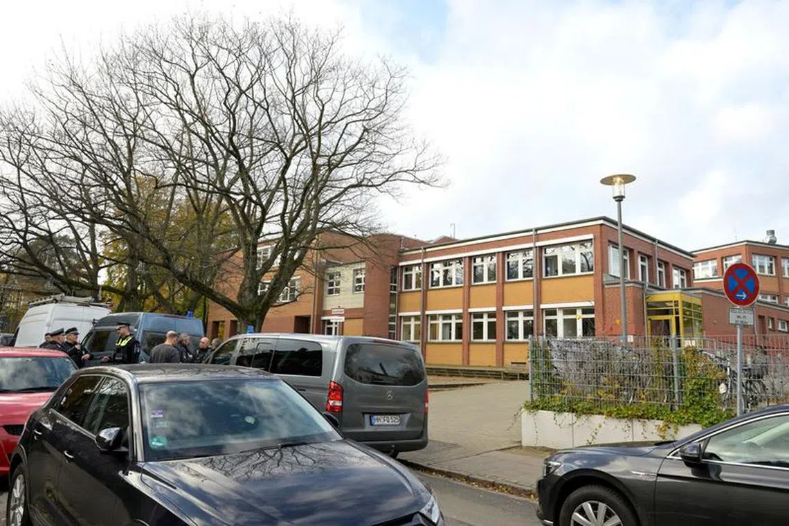 Police officers stand as they check reports of a threat situation at a school in the Blankenese district after local media said that two armed people had barricaded themselves in a classroom in Hamburg, Germany, November 8, 2023. REUTERS/Fabian Bimmer