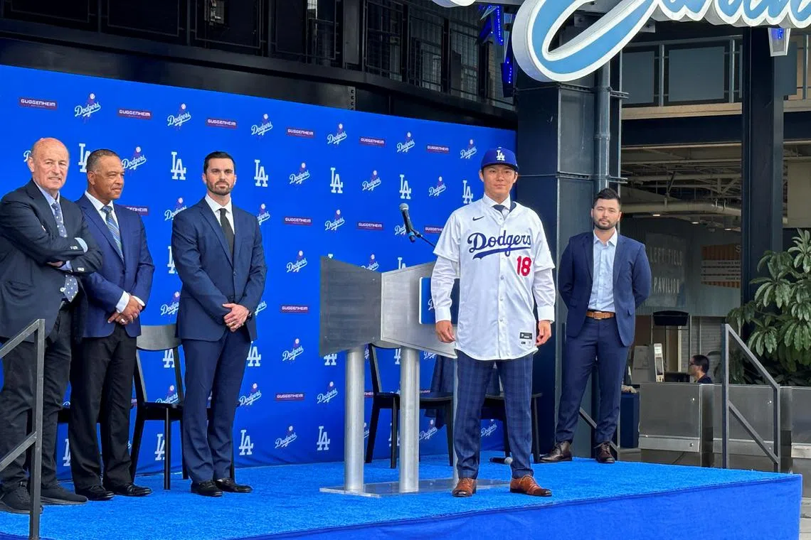 Dodgers' new Japanese signing Yoshinobu Yamamoto poses during an introductory press conference in Los Angeles.