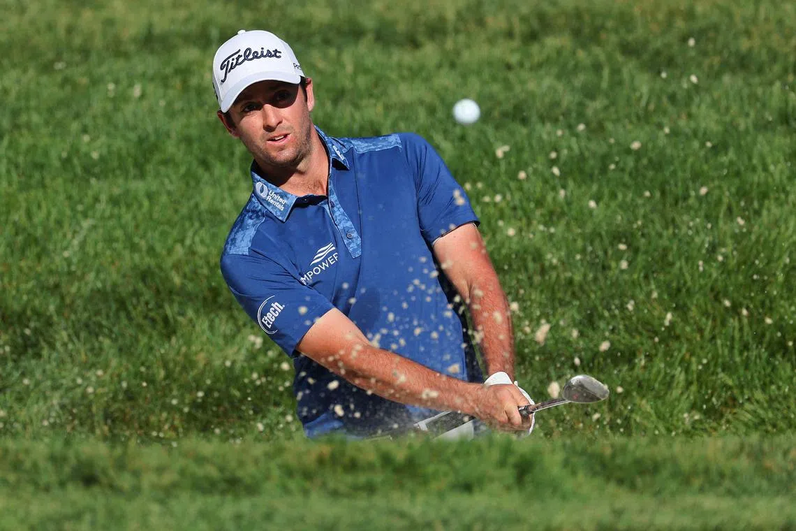 Davis Riley of the United States plays a shot from a bunker on the eighth hole during the first round of the Memorial Tournament.