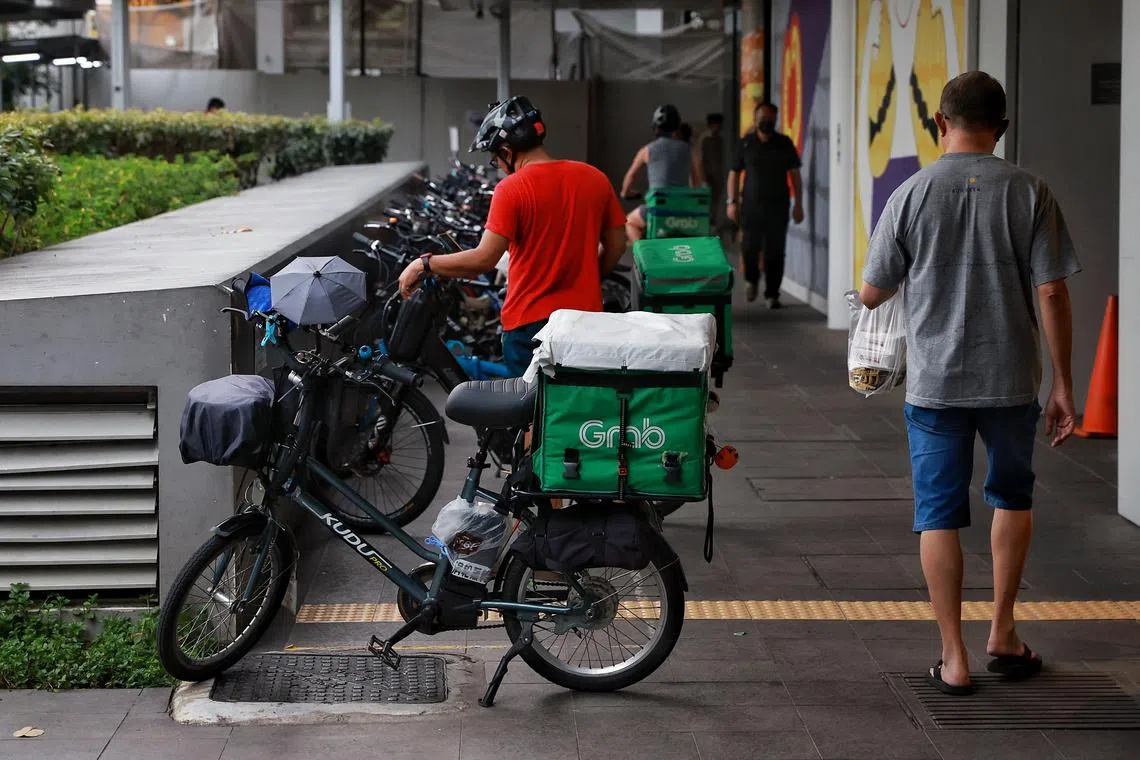 E-bikes and conventional bicycles of delivery riders parked outside White Sands mall on Feb 20, 2023.