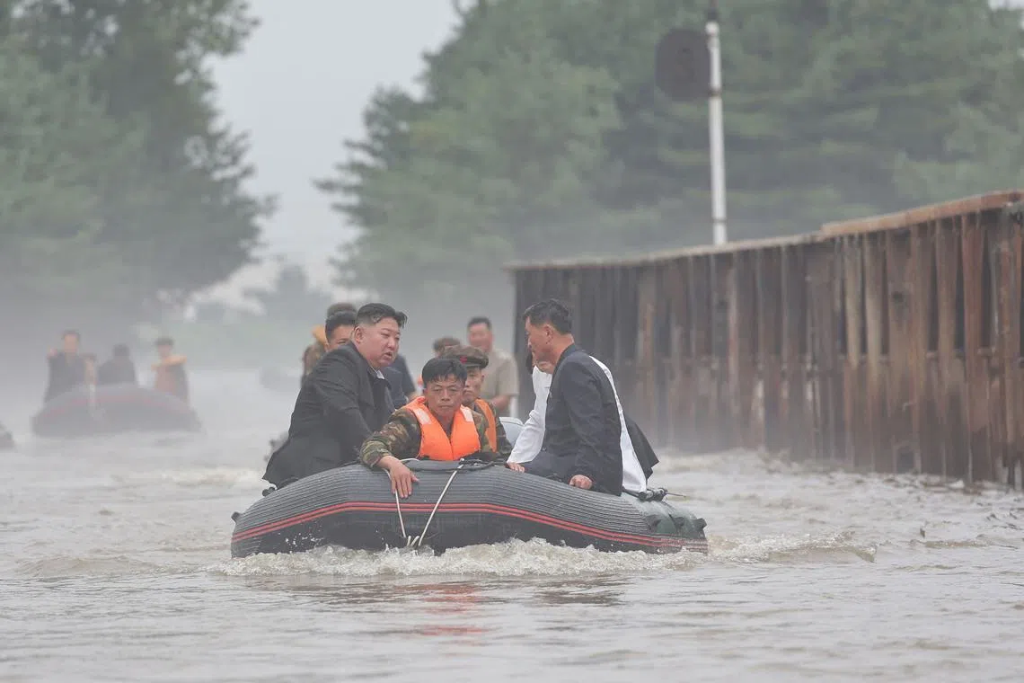 North Korean leader Kim Jong Un and Premier Kim Tok Hun visiting a flood-hit area in North Pyongan province in a photo released on July 31.