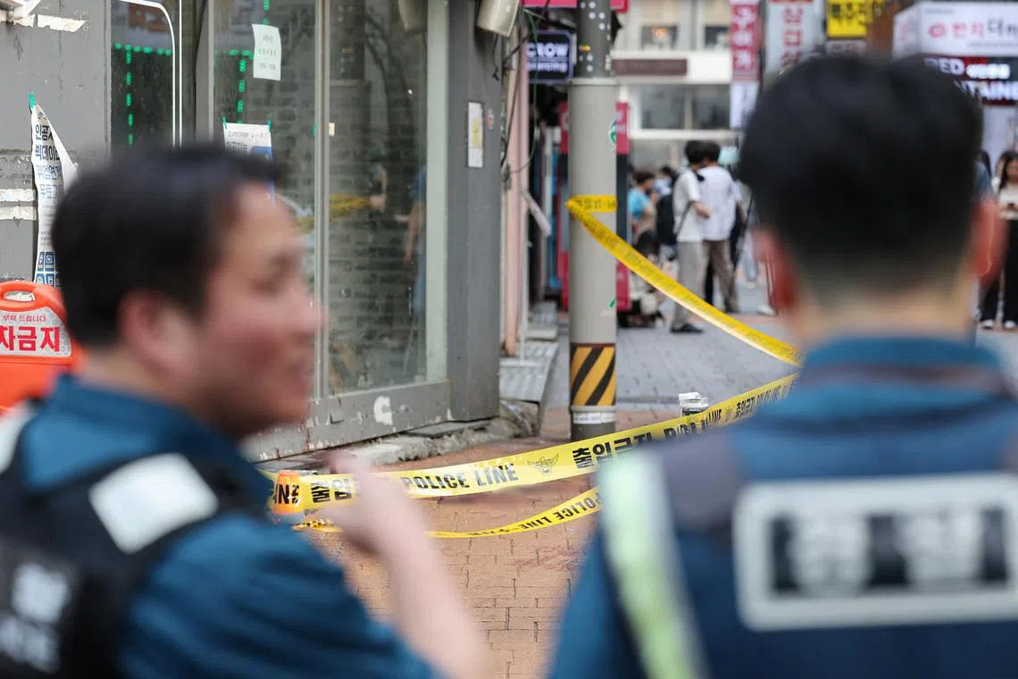 Policemen look at the scene of a stabbing attack by un identified man in his 30s in which one person was killed and three wounded near a subway station, in Seoul, South Korea, July 21, 2023.   Yonhap via REUTERS   THIS IMAGE HAS BEEN SUPPLIED BY A THIRD PARTY. NO RESALES. NO ARCHIVES. SOUTH KOREA OUT. NO COMMERCIAL OR EDITORIAL SALES IN SOUTH KOREA.