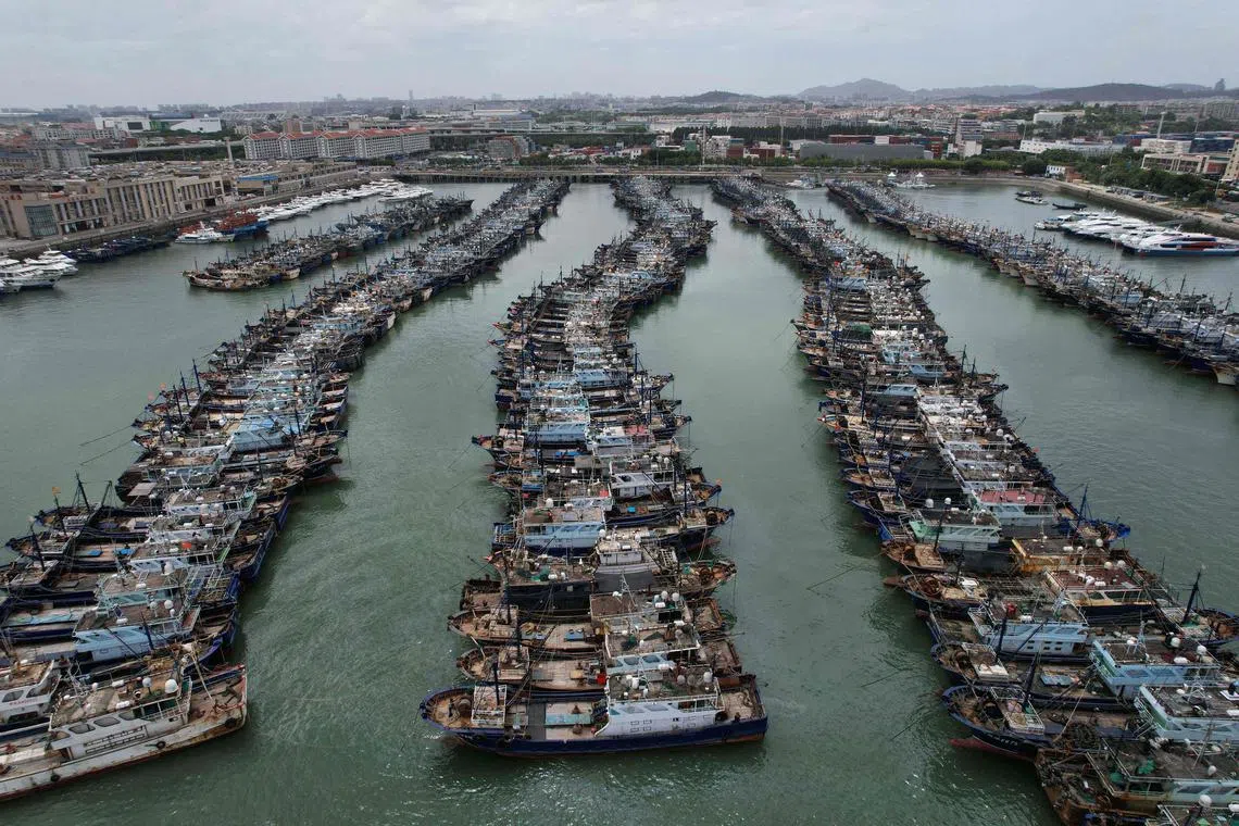 Fishing boats are moored at a port in the Gaoqi locality of Xiamen city at Fujian province in preparation for the approaching Typhoon Doksuri on July 26, 2023. China on July 26, 2023, issued its highest alert for Typhoon Doksuri, stopping trains and calling fishing boats to shore as the storm approaches. 