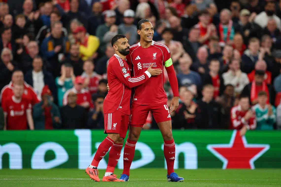 Soccer Football - UEFA Champions League - Liverpool v Atletico Madrid - Anfield, Liverpool, Britain - September 17, 2025 Liverpool's Mohamed Salah celebrates scoring their second goal with Virgil van Dijk Action Images via Reuters/Andrew Boyers