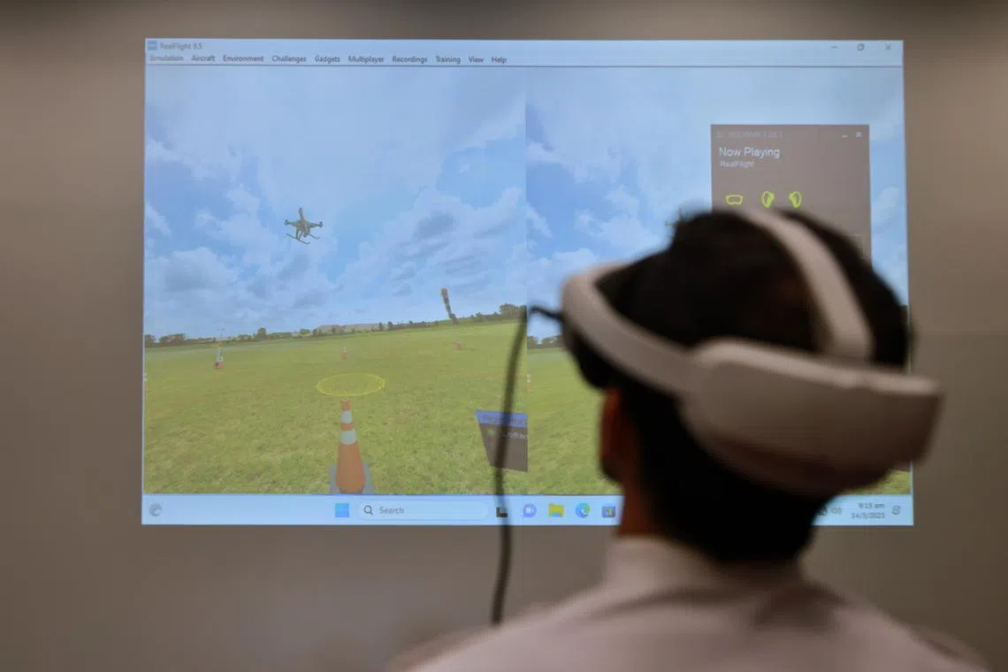 Jason Quah Saeed Rahati, Head of UA Training, Singapore Flying College, demonstrating a virtual reality flight simulator, on March 14.