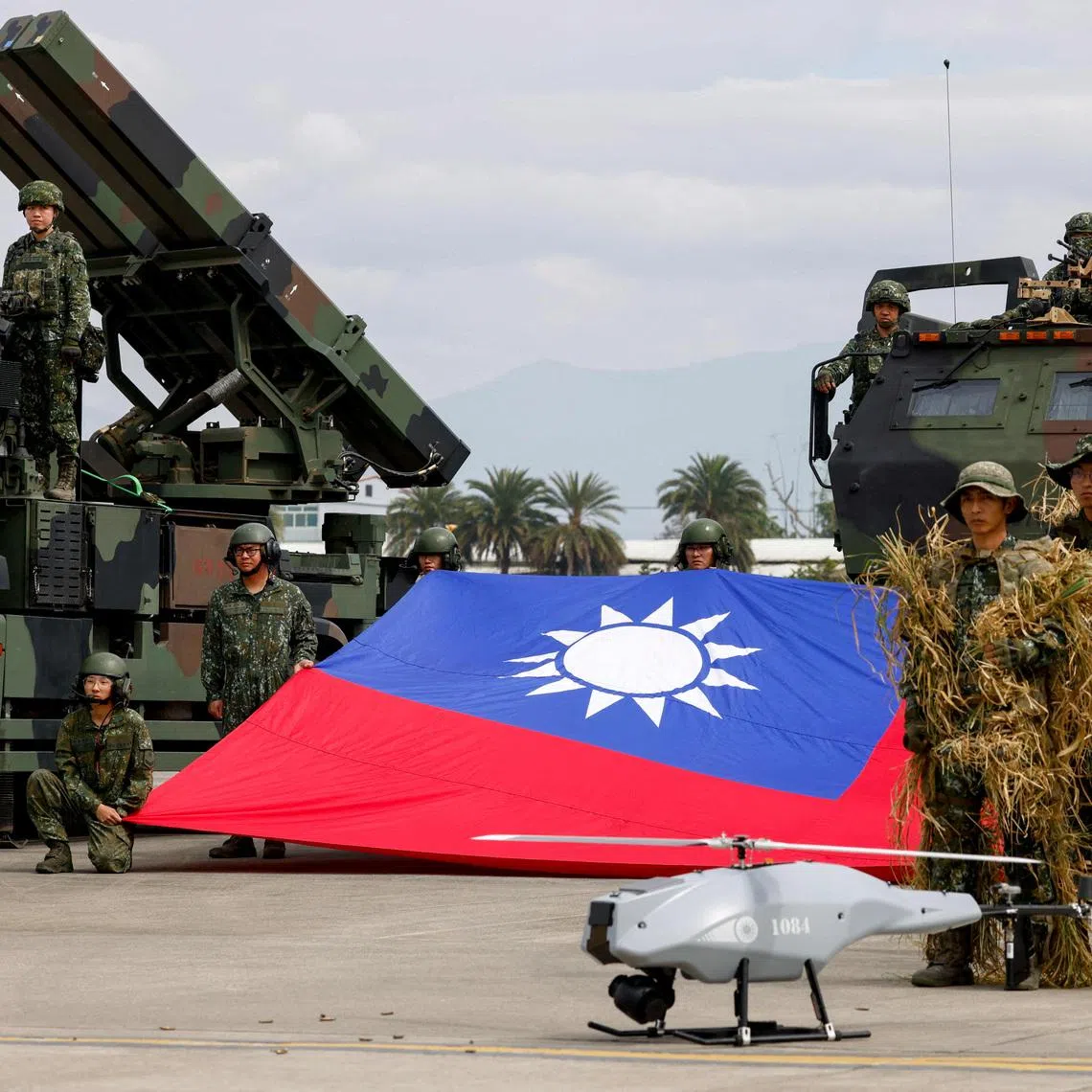Taiwanese soldiers pose with a Taiwanese flag near a Sky Sword II surface-to-air missile launcher and a military UAV during an annual military exercise ahead of Lunar New Year in Taichung, Taiwan, January 27, 2026.