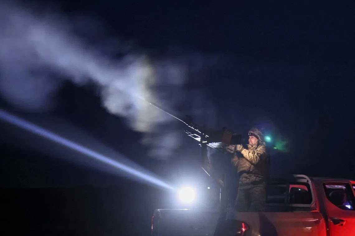A Ukrainian serviceman from anti-drone mobile air defence unit fires a Browning machine gun at his position during combat, amid Russia's attack on Ukraine, in Chernihiv region, Ukraine March 28, 2024. REUTERS/Gleb Garanich/File Photo