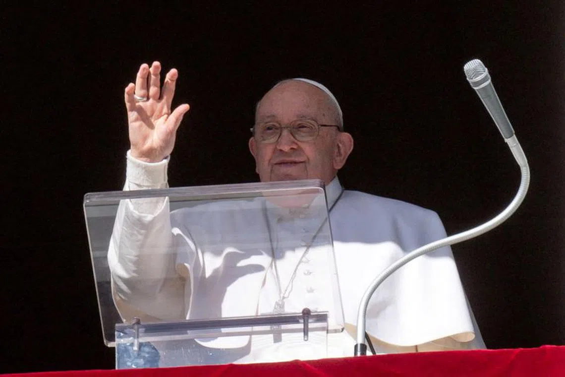 Pope Francis waves at the crowd, who are gathered on St Peter's Square during the Angelus prayer, from his window at the Vatican, January 21, 2024. Vatican Media/­Handout via REUTERS