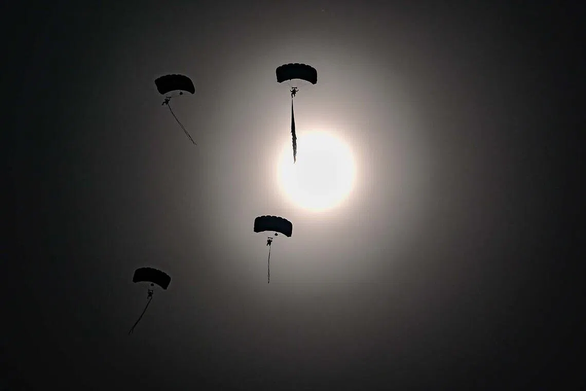 A group of parachuters descending at the opening day of International Aerospace Exhibition in Schoenefeld, near Berlin on June 10.