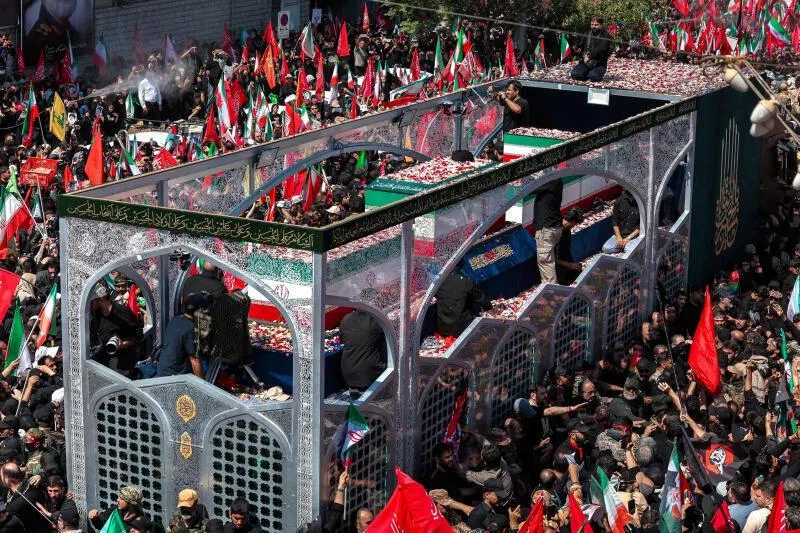 A vehicle carrying the coffins of Iran’s late Supreme Leader Ayatollah Ali Khamenei and his family members makes its way through a crowd of mourners in Tehran on July 6.
