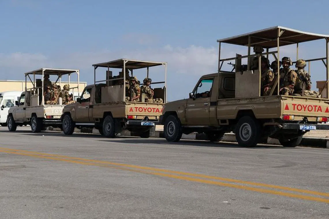 Egyptian members of the military sit in trucks as humanitarian aid from for Palestinians waits for the reopening of the Rafah border crossing on the Egyptian side to enter Gaza, amid the ongoing conflict between Israel and the Palestinian Islamist group Hamas, at Al Arish airport, Egypt October 20, 2023. REUTERS/Amr Abdallah Dalsh