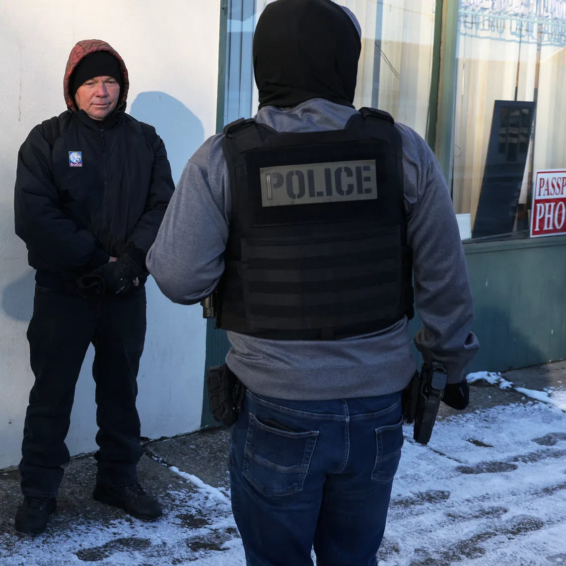 A Federal agent questions a man, who showed his Temporary Protected Status (TPS) and had came to the U.S. 25 years ago from El Salvador, during immigration removal operations in the Long Island town of Hempstead, New York, U.S., January 19, 2026. REUTERS/Shannon Stapleton