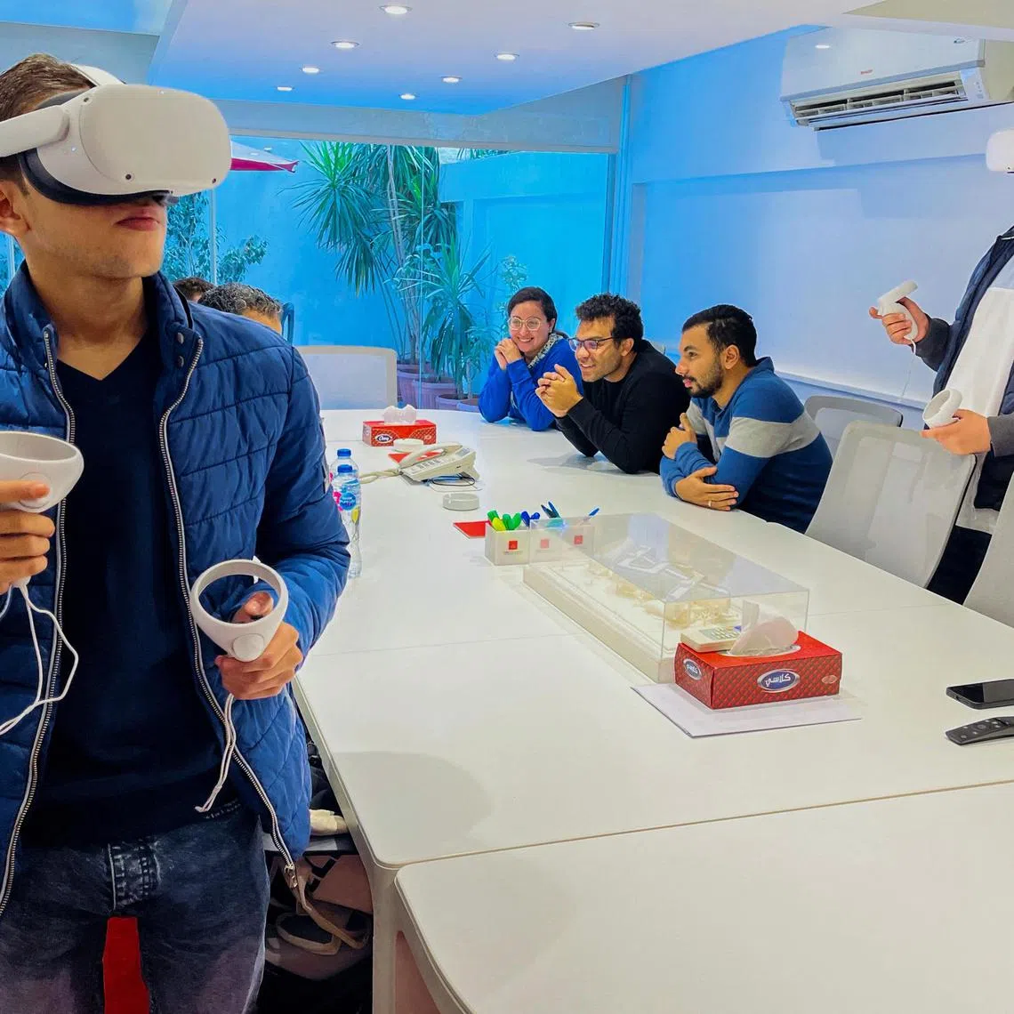 Designers of an Egyptian virtual city touring the metaverse using virtual reality equipment in Cairo, on Dec 5, 2022.