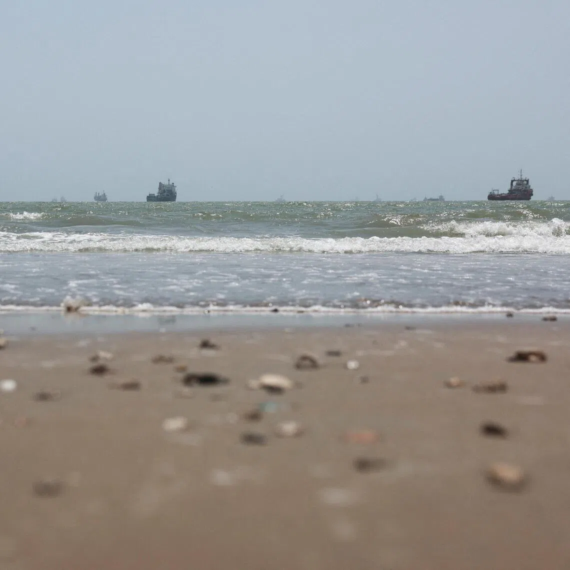 Vessels in the Strait of Hormuz are visible near the beach of Bandar Abbas, Iran, on Aug 25.