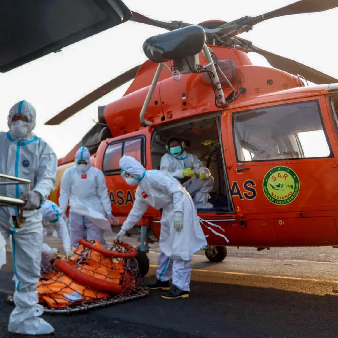 A handout photo on Sept 20, 2026 by Basarnas showing rescue officials carrying body bags with the remains of victims recovered from the Virgo Transport 8 ship accident, upon arrival by helicopter at Syamsudin Noor Airport in Banjarmasin in South Kalimantan.