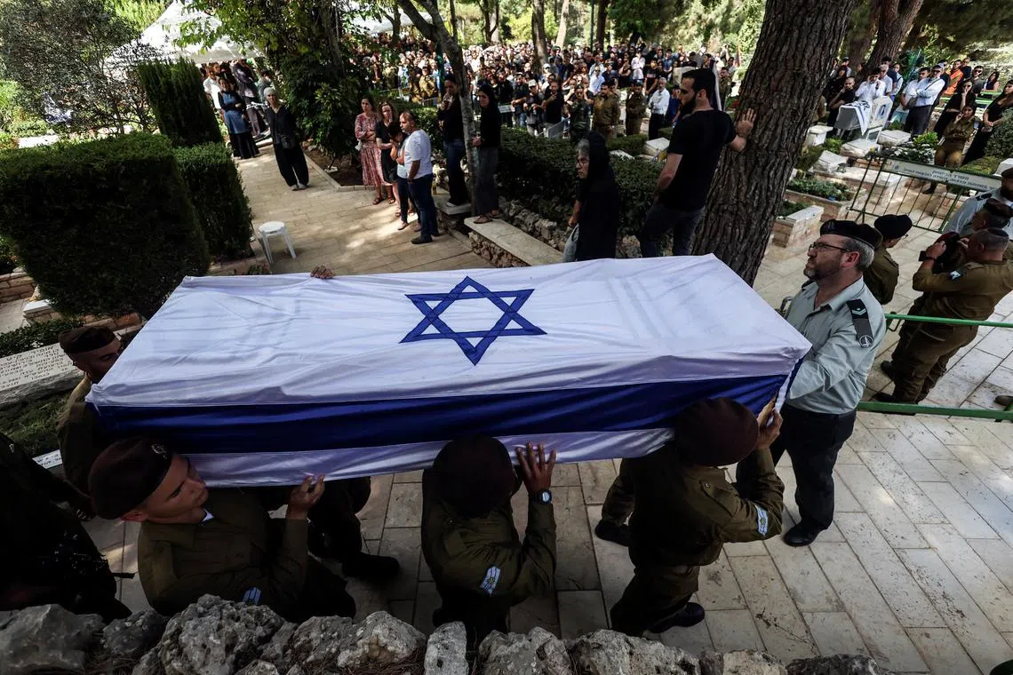 Soldiers carry the coffin of their fallen comrade Adi Zur, who was slain by Hamas gunmen who tore through southern Israel.