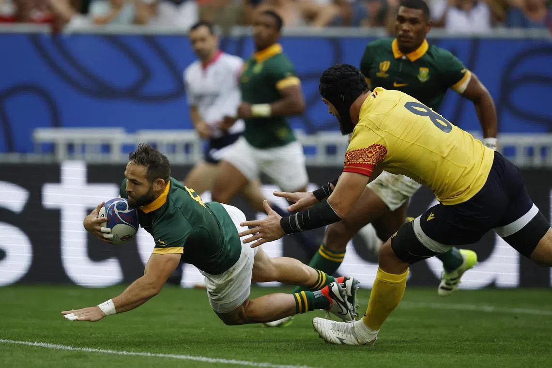 South Africa's Cobus Reinach scoring the first of their 12 tries in a 76-0 thrashing of Romania at the Rugby World Cup on Sunday.