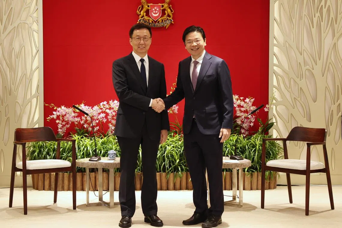 Chinese Vice-Premier Han Zheng meeting DPM Lawrence Wong in Singapore on Tuesday.