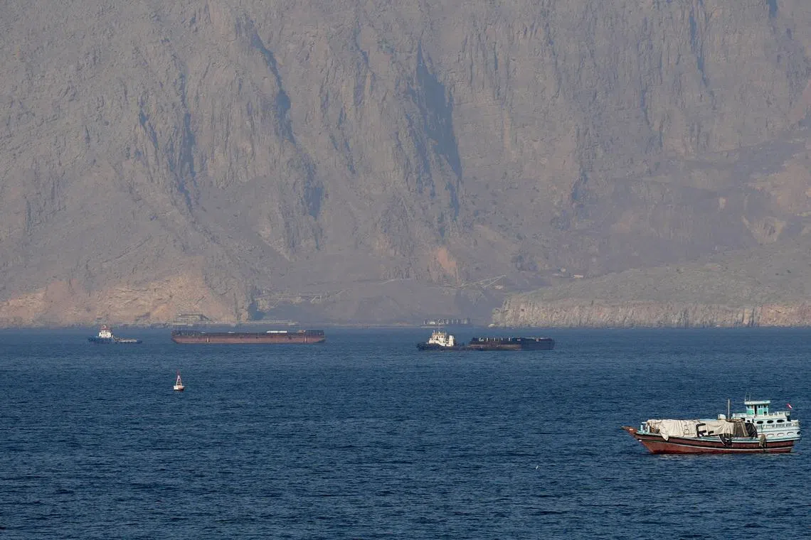 Ships and tankers in the Strait of Hormuz off the coast of Musandam, Oman. Escorting them safely will require immense resources, says the writer. 