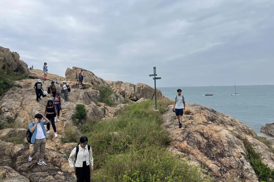 Tourists on a rocky outcrop on Po Toi Island in Hong Kong.