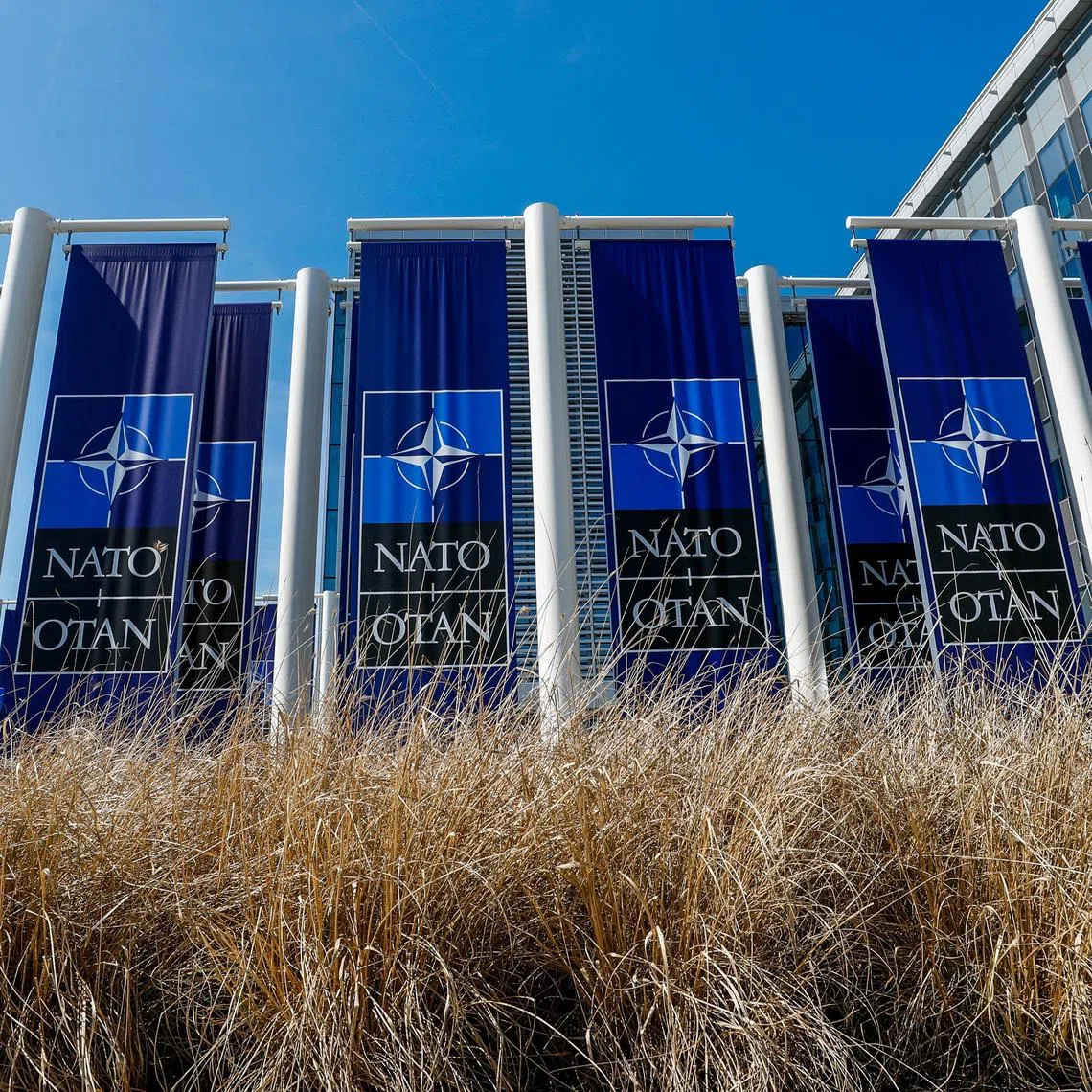 Banners displaying the NATO logo are placed at the entrance of new NATO headquarters during the move to the new building, in Brussels, Belgium April 19, 2018.  REUTERS/Yves Herman