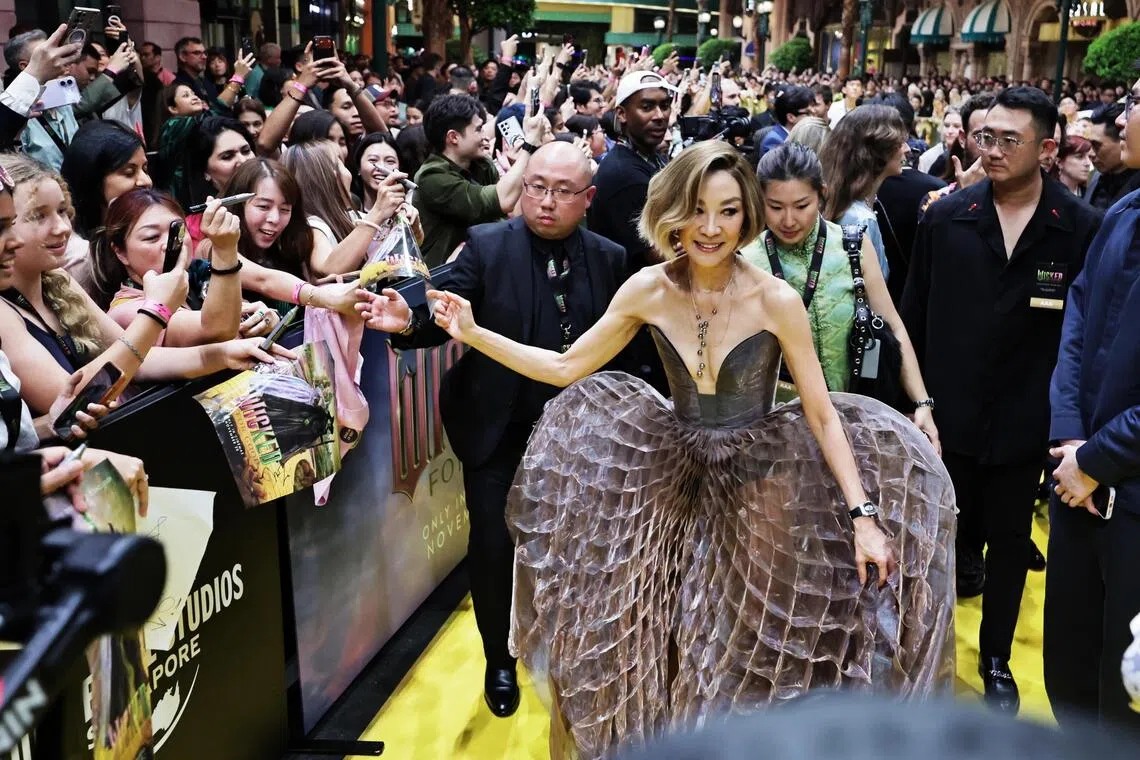 Michelle Yeoh interacting with fans along the yellow carpet during the premiere of the Wicked: For Good in Universal Studios Singapore on Nov 13, 2025.