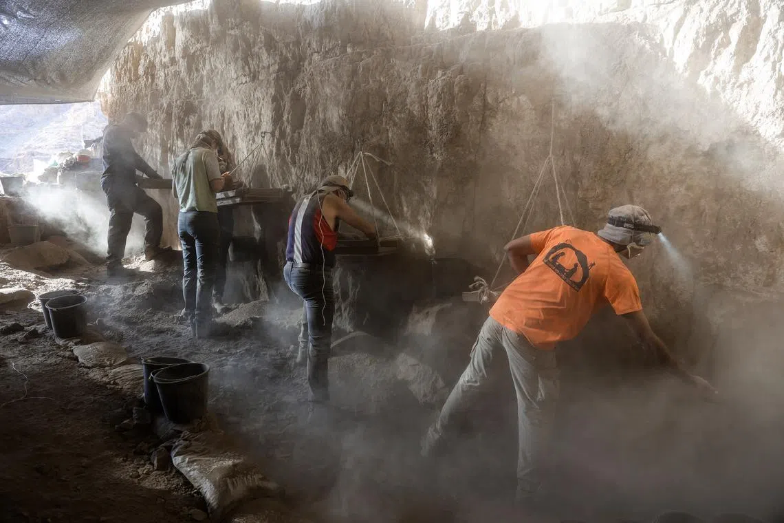 Volunteers of the Israel Antiquities Authority look for archaeological finds in the Murabba'at cave in the Judean Desert near Metzuki Dargot village, close to the Dead Sea, Israel, 28 December 2022. 