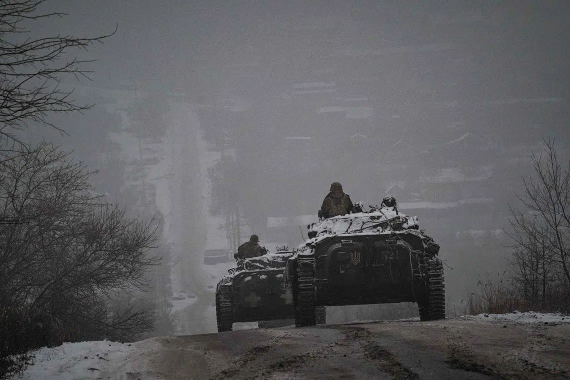 Ukrainian servicemen ride atop BMP-2 infantry combat vehicles in Ukraine's Donetsk region, on Jan 30, 2023,