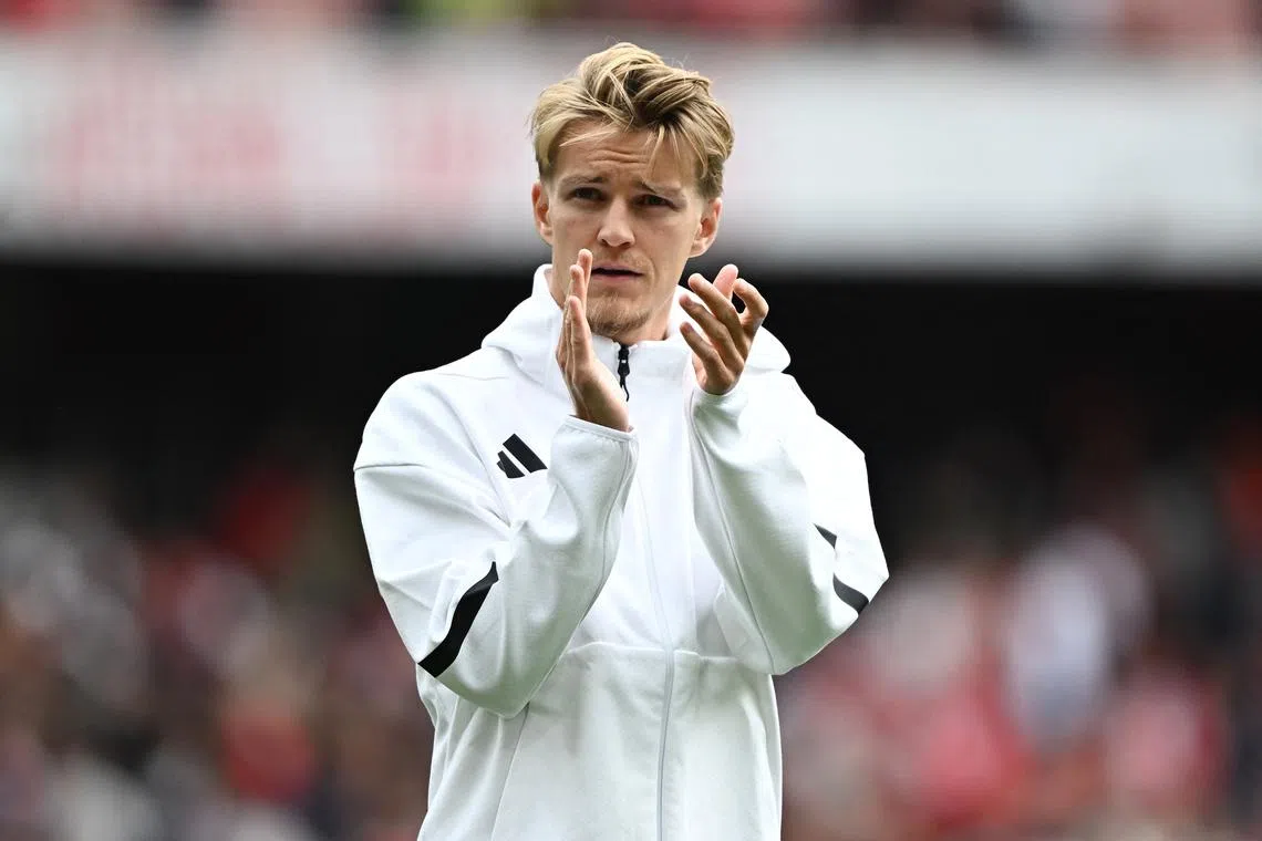 FILE PHOTO: Soccer Football - Premier League - Arsenal v Brighton & Hove Albion - Emirates Stadium, London, Britain - August 31, 2024 Arsenal's Martin Odegaard applauds fans after the match REUTERS/Dylan Martinez/File Photo