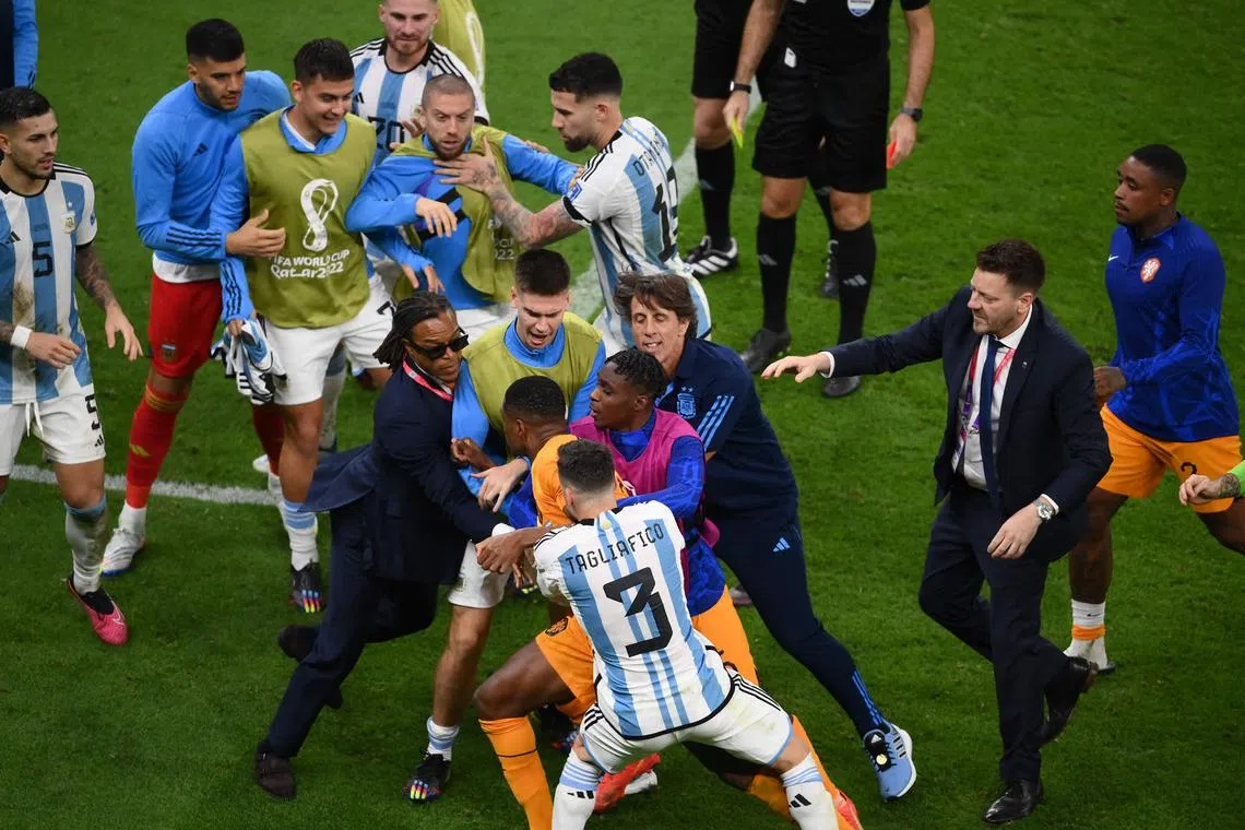 Former Netherlands player Edgar Davids (bottom left) intervenes as Dutch and Argentina players clash during the World Cup quarter-final on Friday.
