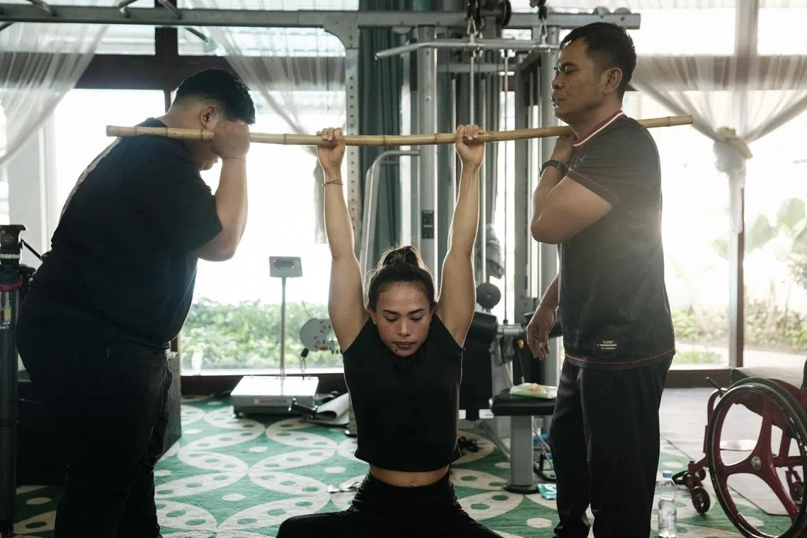 Indonesian para-powerlifter Ni Nengah Widiasih working out during the national team's training camp at the Kusuma Sahid Prince Hotel in Surakarta, ahead of the Paris 2024 Paralympic Games which start on Aug 28. 