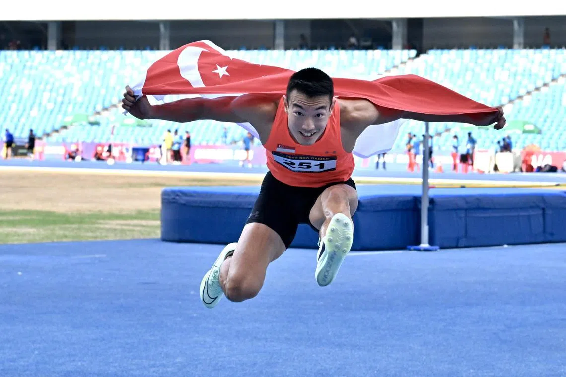 Singapore’s Ang Chen Xiang goes flying with the Singapore flag after his 110m hurdles race on May 10. Hours later, his silver became a joint gold. 