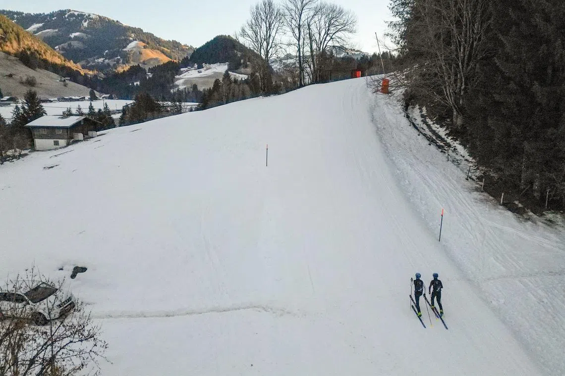 A drone view shows twin brothers Robin and Thomas Bussard climbing up during a ski mountaineering training session in Rougemont, Switzerland, December 18, 2025. REUTERS/Denis Balibouse