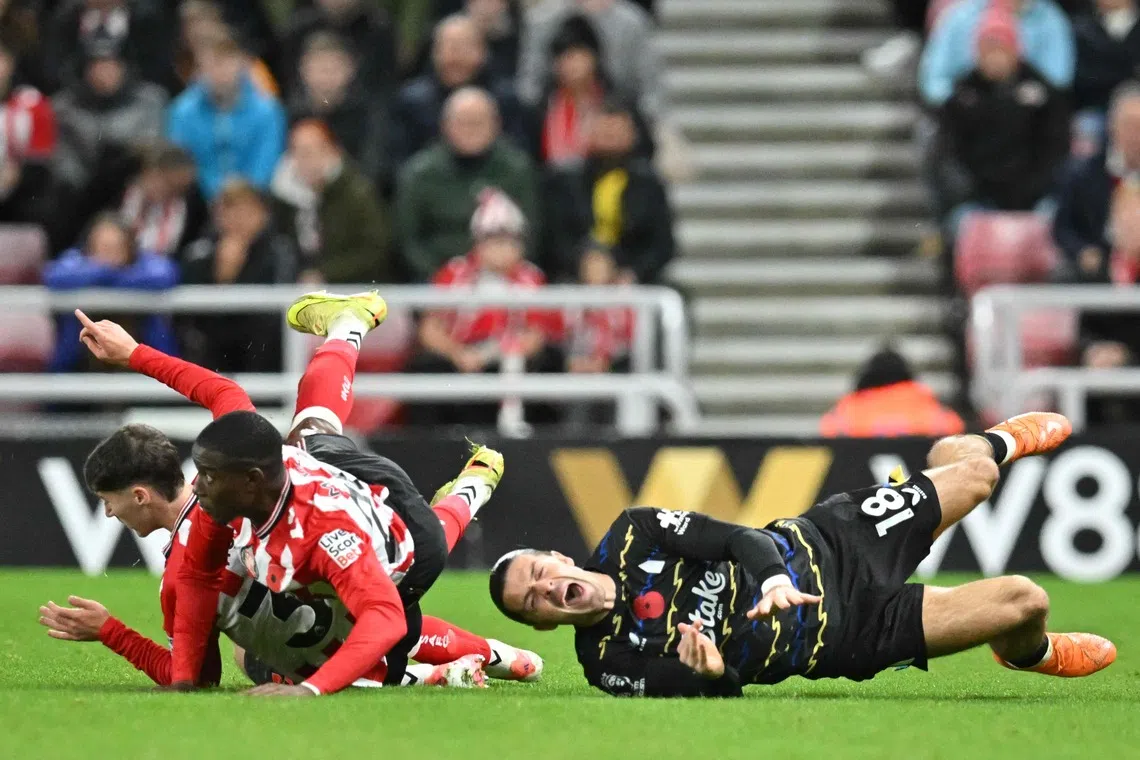 Everton FC midfielder Jack Grealish (R) reacting after being fouled by Sunderland's Northern Irish defender Trai Hume  during the English Premier League football match between Sunderland and Everton at The Stadium of Light in Sunderland in north east England on Nov 3, 2025. (