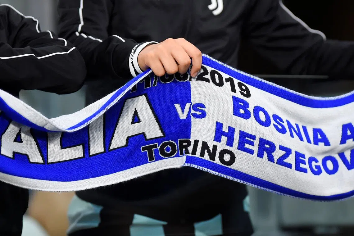 FILE PHOTO: Soccer Football - Euro 2020 Qualifier - Group J - Italy v Bosnia and Herzegovina - Allianz Stadium, Turin, Italy - June 11, 2019  General view of a fan holding a scarf before the match   REUTERS/Massimo Pinca/File Photo